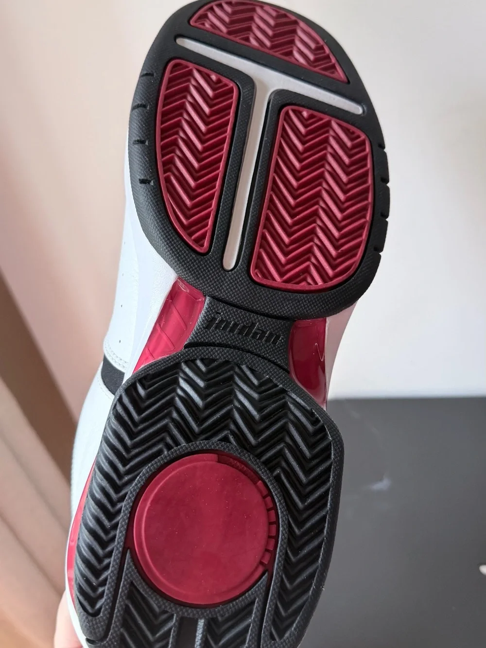 Nike Jordan Team Reign Low sneakers in a white, black, and red colorway,